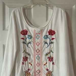 White with flower embroidery. Size Large, roomy fit.